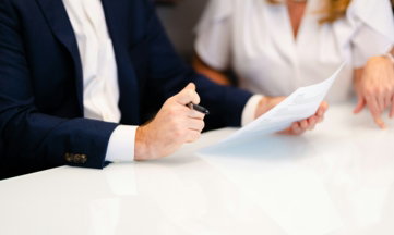 a-man-and-a-woman-sitting-at-a-white-table.jpg a man and a woman sitting at a white table